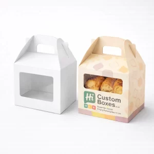 Small cardboard carrier boxes with a clear window and handle, containing toasted bread rolls.