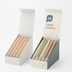 Display boxes, plain white and decorated, featuring six taper candles in various pastel shades.