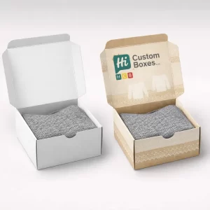 Sustainable open-top mailer boxes in white and kraft paper, displaying a grey woollen sweater inside.