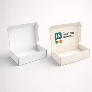 Two open mailing boxes, one plain white and one featuring a cream floral damask pattern with branding.