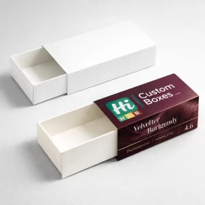 A white drawer-style box next to a custom-printed burgundy hair colour box with a sleeve.