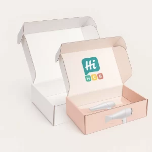 Two open salmon-pink and white gift-style boxes showing internal branding and hair dryer illustrations.