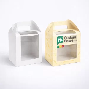 Two white carrier boxes with integrated handles, one blank and one featuring bakery product imagery.