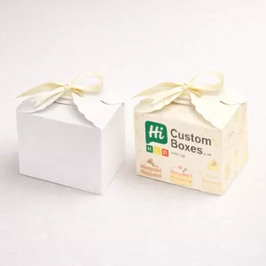 Two white gift boxes tied with blue ribbons, one plain and one featuring custom branding.