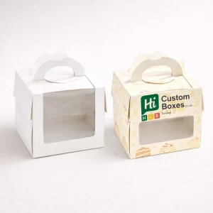 Two white carrier boxes with integrated handles, one blank and one featuring bakery product imagery.