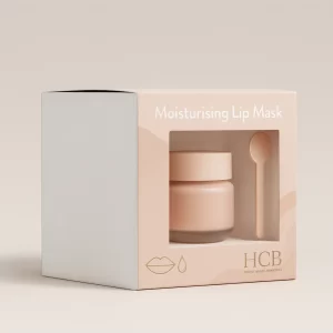 A square peach box with a window showing a lip mask jar and spoon