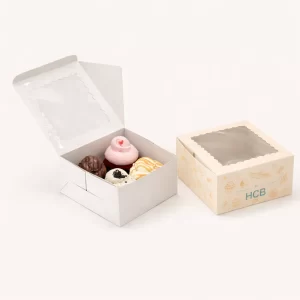 Two open vertical cardboard boxes, one plain white and one with vibrant teal wave-themed printing.
