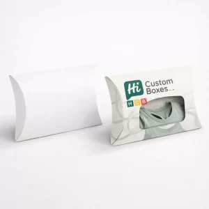Two white pillow-shaped boxes, one plain and one with a branded window showing a bralette.