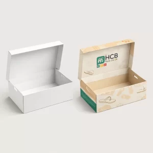 An open white hinged lid box next to a beige branded box showing internal graphics.