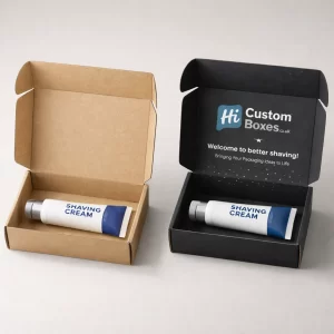 An open brown cardboard mailer box next to a black branded mailer box, both containing shaving cream tubes.