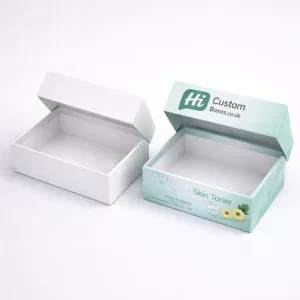Two white hanging tab boxes, one plain and one with blue medical skin toner labelling.