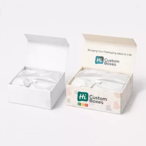 Two open corrugated shipping cartons, one plain white and one with branding and a skirt-patterned print.