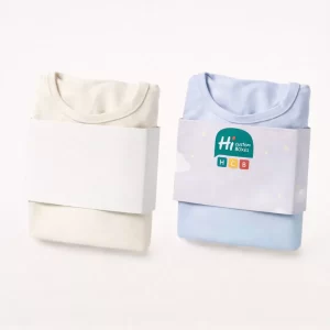 Folded white and blue sleepwear tops secured with matching paper belly bands around the middle.