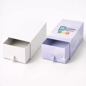 Two sliding drawer boxes, one plain white and one lilac with a celestial night-sky pattern.