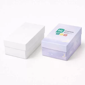 A plain white rectangular box next to a lilac box printed with clouds and stars.