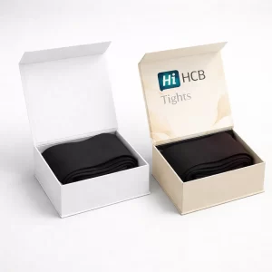 Two luxury magnetic-closure boxes, shown open to reveal folded black tights inside with elegant branding.