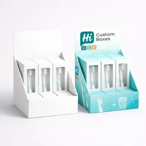 Countertop display units filled with individual toothbrush boxes- featuring a branded header and teal graphics