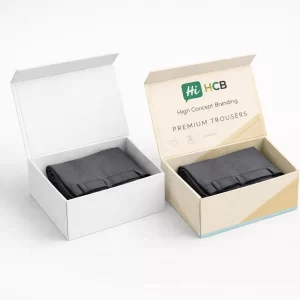 Two mailer boxes, one plain white and one branded, containing folded grey trousers for wholesale.