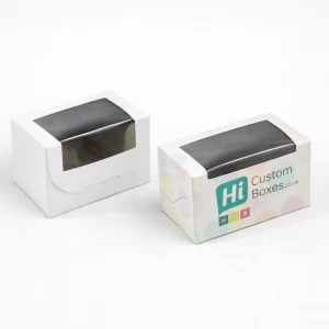 Two small white boxes with large clear windows, one plain and one with branded pastel patterns.