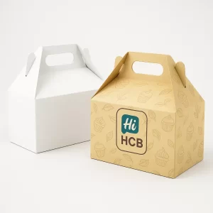 Two wide white and cream gable style cake boxes with curved handles and festive printed designs.