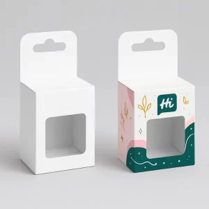 Hanging window packaging boxes, one plain white and one decorated with pink, teal, and gold graphics featuring leaves, stars, and "Hi" logo.