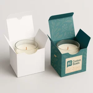 Two cube-shaped boxes, plain white and decorated, containing a glass-jar tealight candle.