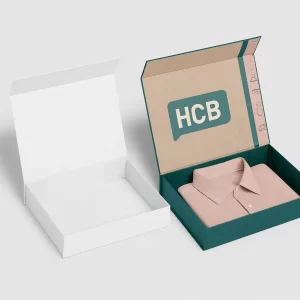 Open mailer shirt boxes- one plain white and the other teal with pink accents and -HCB- branding- displaying a folded pink collared shirt inside