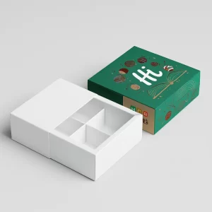 White and branded drawer-style boxes, open, showing four internal partitions for truffles.