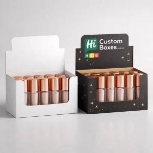 Two cardboard display boxes holding multiple rose gold liquid highlighter bottles, in white and black designs.