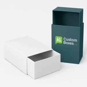 Custom slide-out drawer boxes- or two-piece rigid boxes with sliding sleeves- One box is a plain white drawer style- and the other is a custom-printed dark teal sleeve box