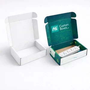 Two open mailer boxes, one minimalist white and one teal branded box containing an extension lead.