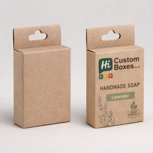 Two upright brown kraft soap boxes with hanging tabs, featuring a minimalist lavender design and eco-friendly logo.