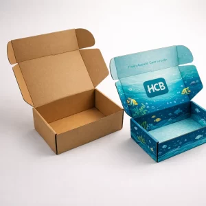 Two open cardboard mailer boxes, one natural kraft brown and one with a blue aquatic coral reef print.