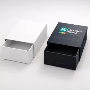 A white sliding drawer box next to a black premium drawer box printed with brand logos.