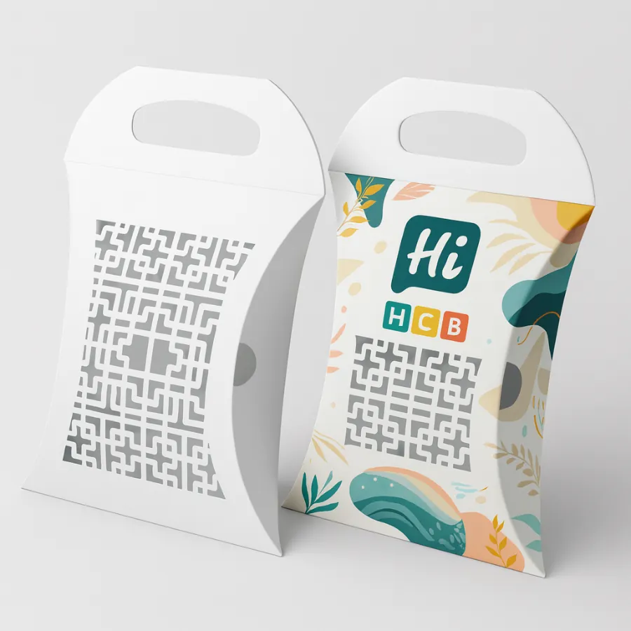 Two pillow boxes with handles- one white die-cut pattern- the other colorful- abstract design with -Hi HCB