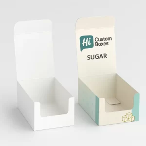 Two open cardboard display boxes for sugar- one plain white and one with blue branding