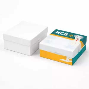 Two square two-piece rigid boxes, one plain white and one featuring a colourful dog illustration.