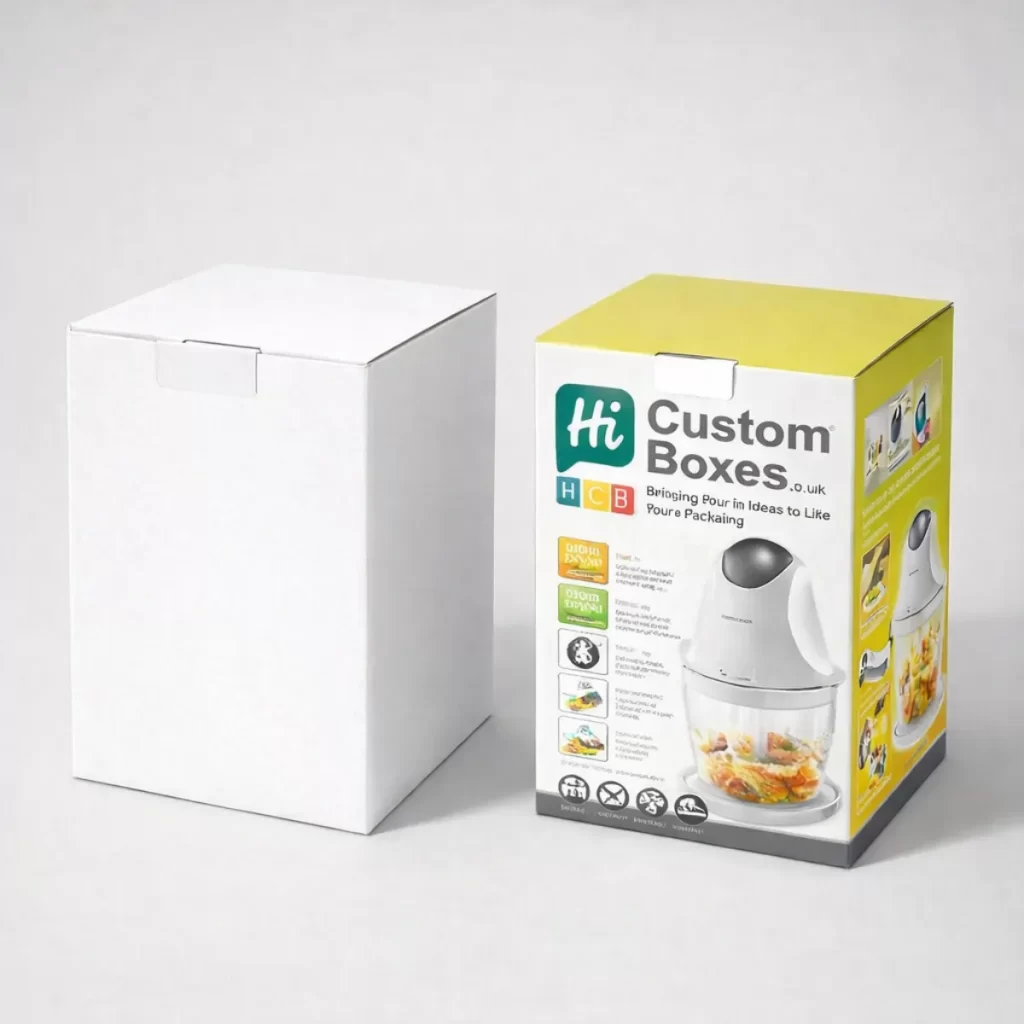 A white cardboard box next to a printed retail box featuring a mini food processor.