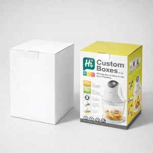 A white cardboard box next to a printed retail box featuring a mini food processor.