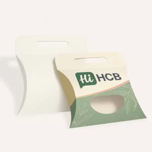 Plain white and decorative pillow boxes with a carry handle and oval viewing window