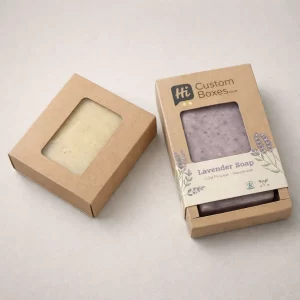 wo brown kraft soap boxes with rectangular cut-out windows, one showing a cream soap bar and one lavender.