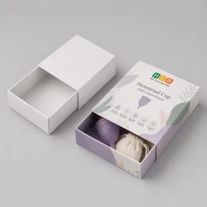 Two square cardboard boxes, one plain white and one with elegant pink floral feminine care branding.
