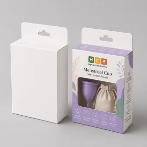 A white retail box standing next to a branded pink box featuring menstrual cup product details.