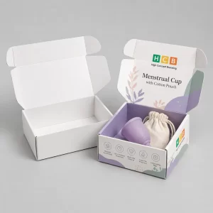 Two flat cardboard mailing boxes, one blank and one decorated with pink floral designs and logos.