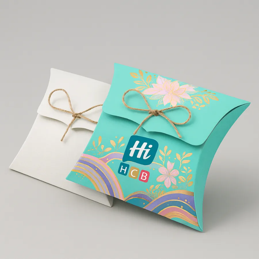 Plain white and vibrant teal pillow boxes- both tied with rustic twine and featuring floral designs