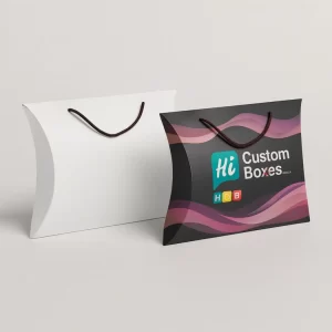 Two pillow boxes with string handles- one plain white and one black with purple waves