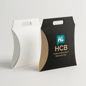 Two pillow-style apparel boxes with handles- one in white and the other in stylish black and gold print