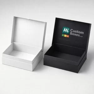 An open white presentation box shown next to an open black branded box for studio headsets.