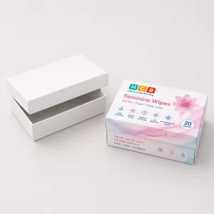 Two small eco-friendly boxes, one blank white and one featuring pink floral patterns and logos.