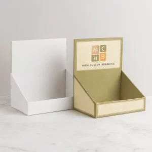 Two upright display boxes one plain white and one custom printed with cream floral design and HCB
